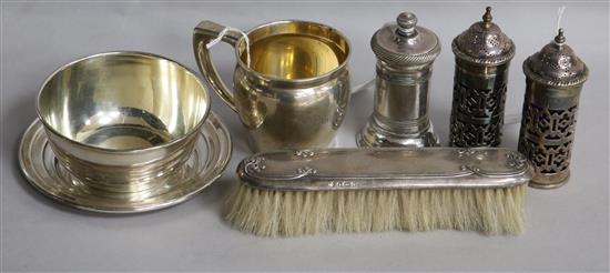 A sterling silver three-piece Christening set, inscribed, a silver-backed clothes brush and three plated items.
